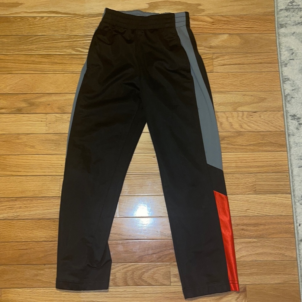 Black gray and red track pants. Size M (8). Two front pockets.
